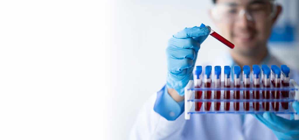 Lab technician holding test tube