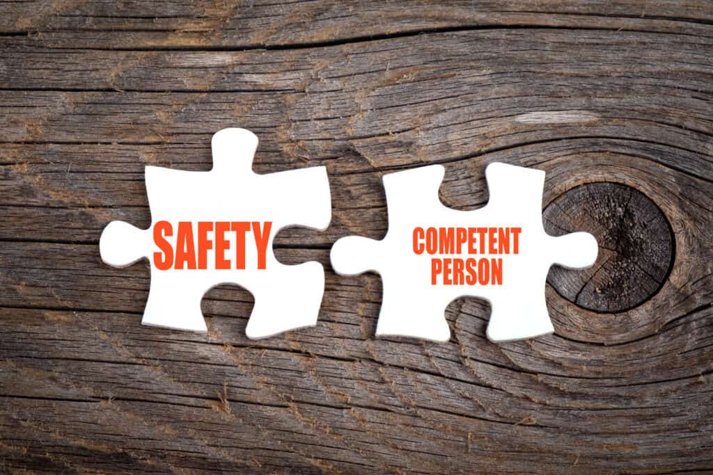 Competent person as words on two jigsaw pieces