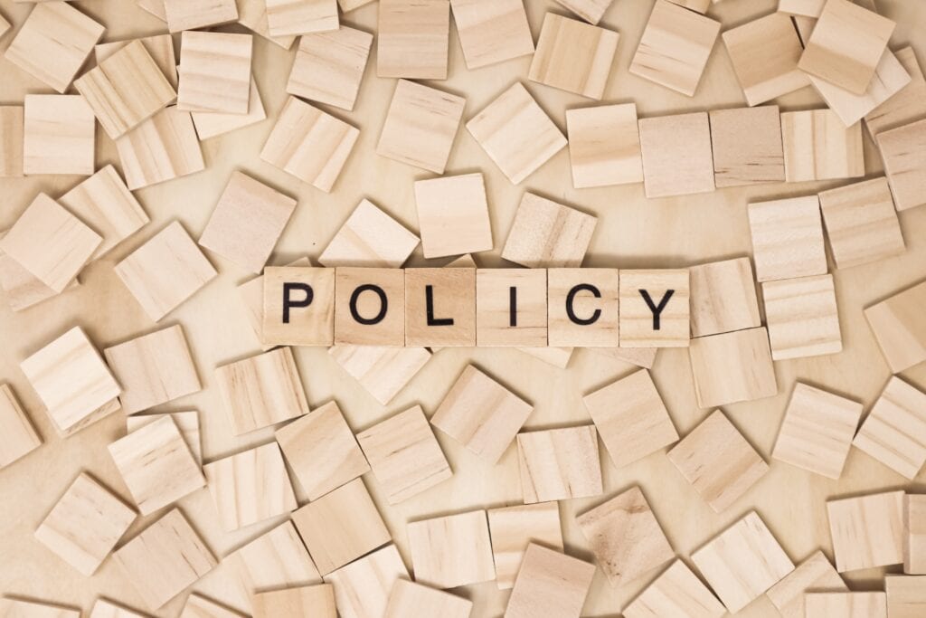 Health and safety policies illustrated as wooden tiles spelling out the word policy.