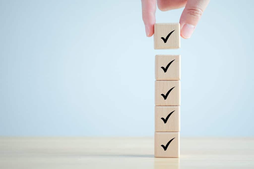 SSIP accreditation - stacking wooden blocks representing a checklist